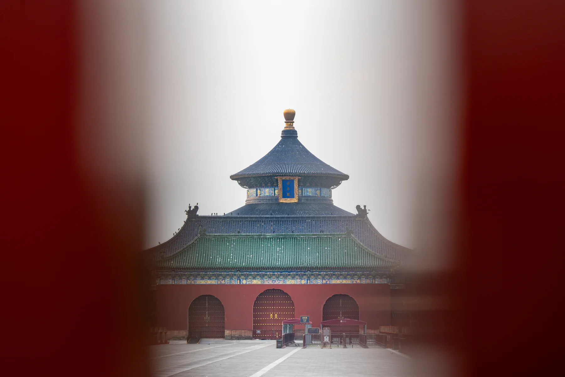 The Temple of Heaven seen quietly through a red doorway