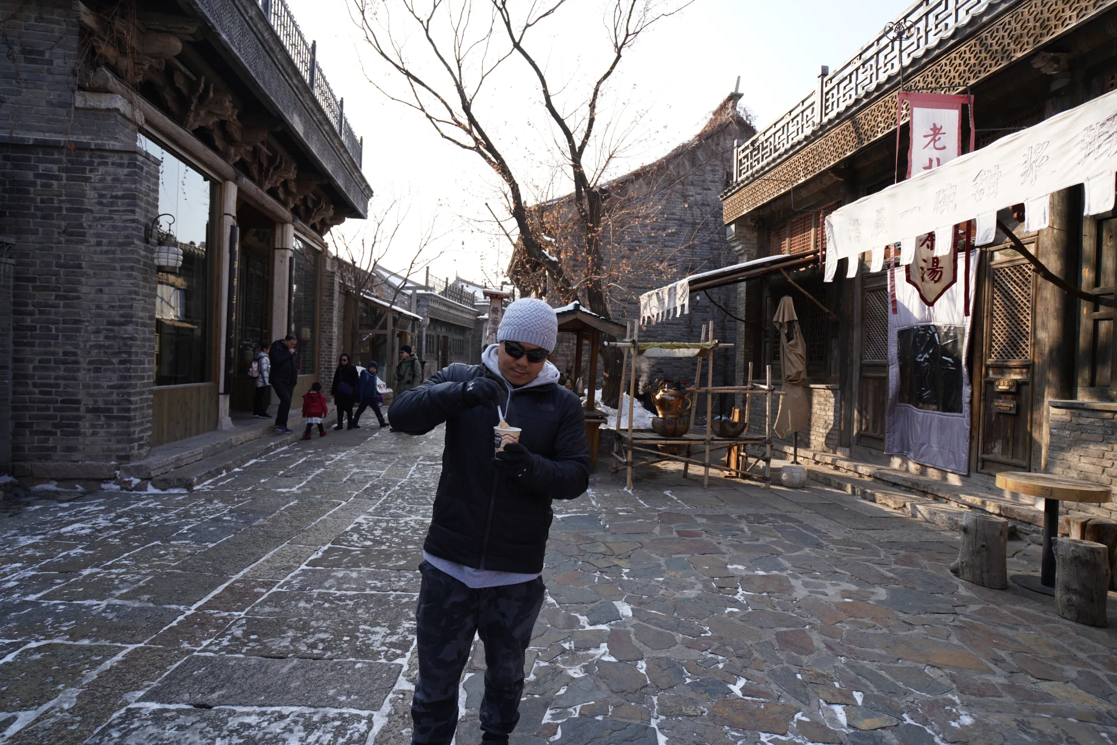 Lao Wang enjoying a local snack in a Beijing street