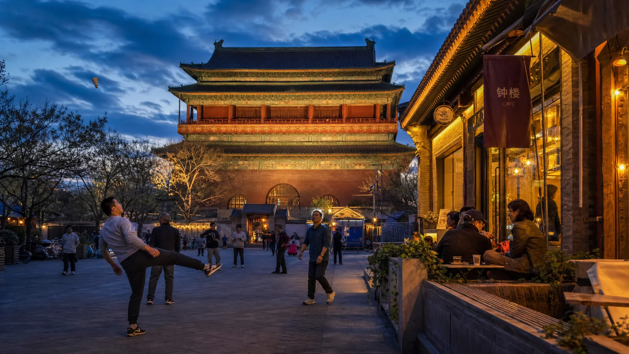 Evening street life beside the illuminated Bell Tower in Beijing