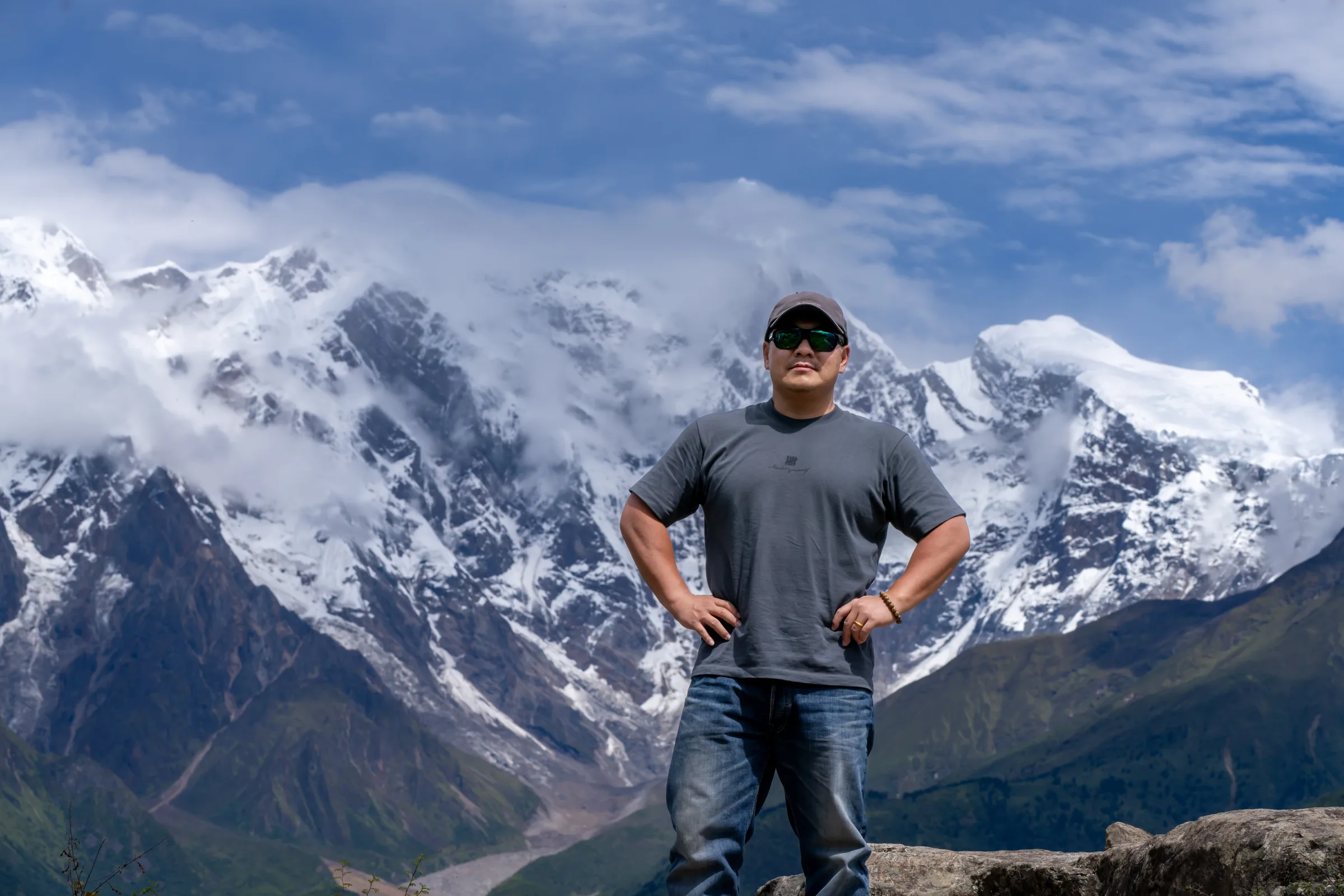 Wang Peng in front of a snow-covered mountain landscape